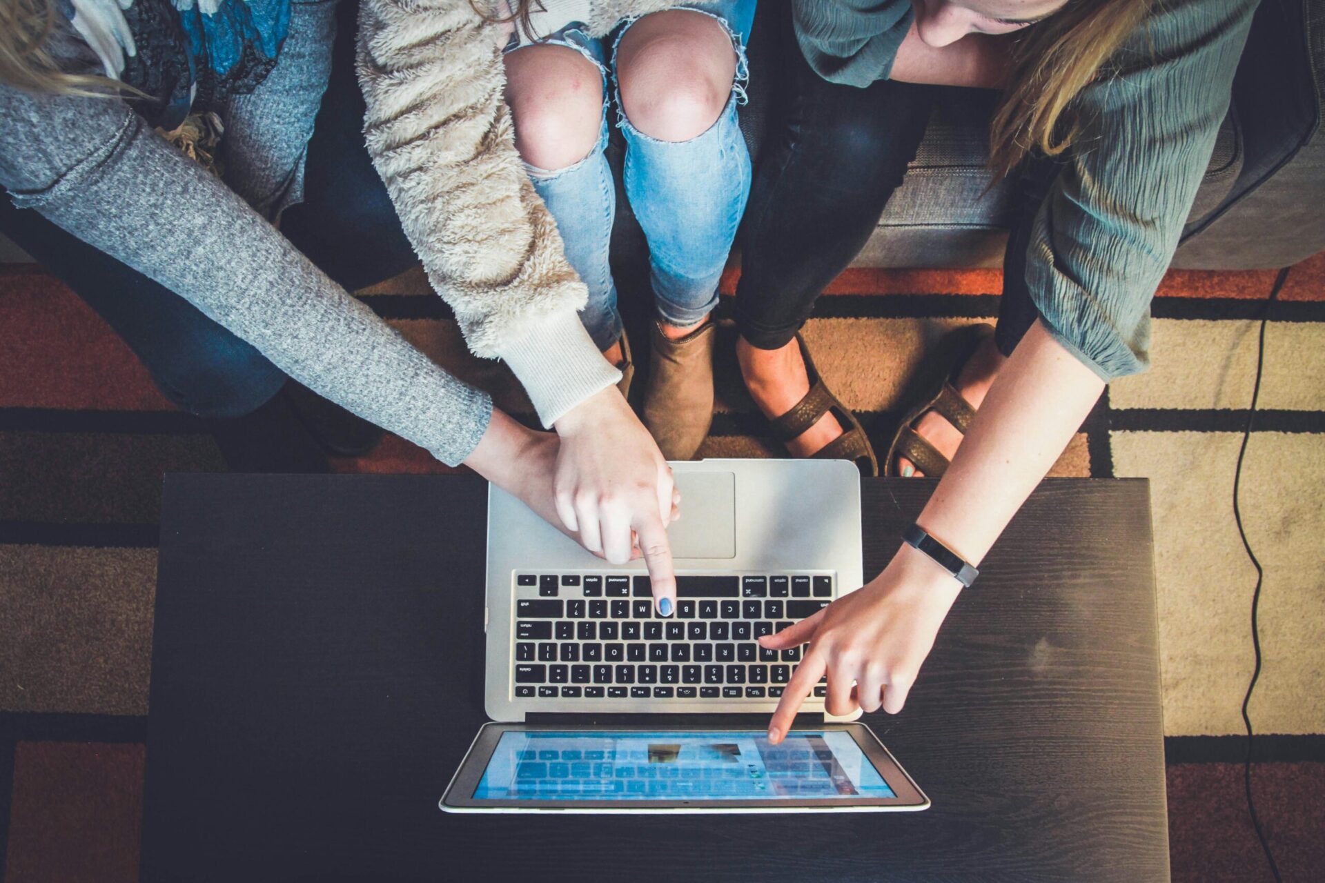 Positive Reviews, three person pointing the silver laptop computer